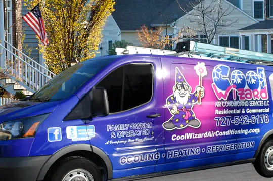 A van with a purple and blue wrap on the side.