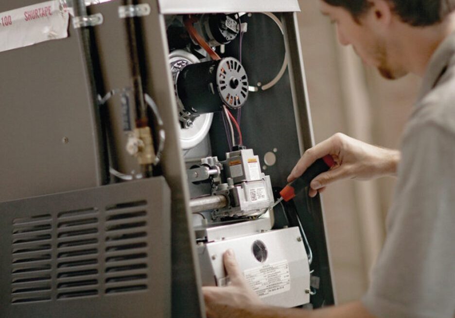 A man working on an older furnace.