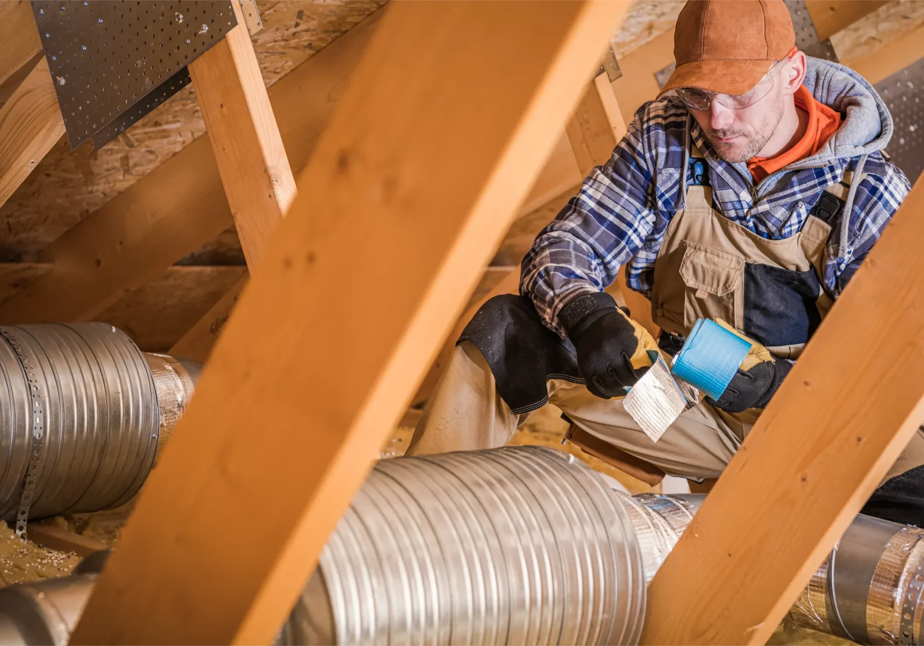 male-contractor-binding-ventilation-pipes-with-duc-2023-11-27-05-13-02-utc air conditioning contractor repairing duct work